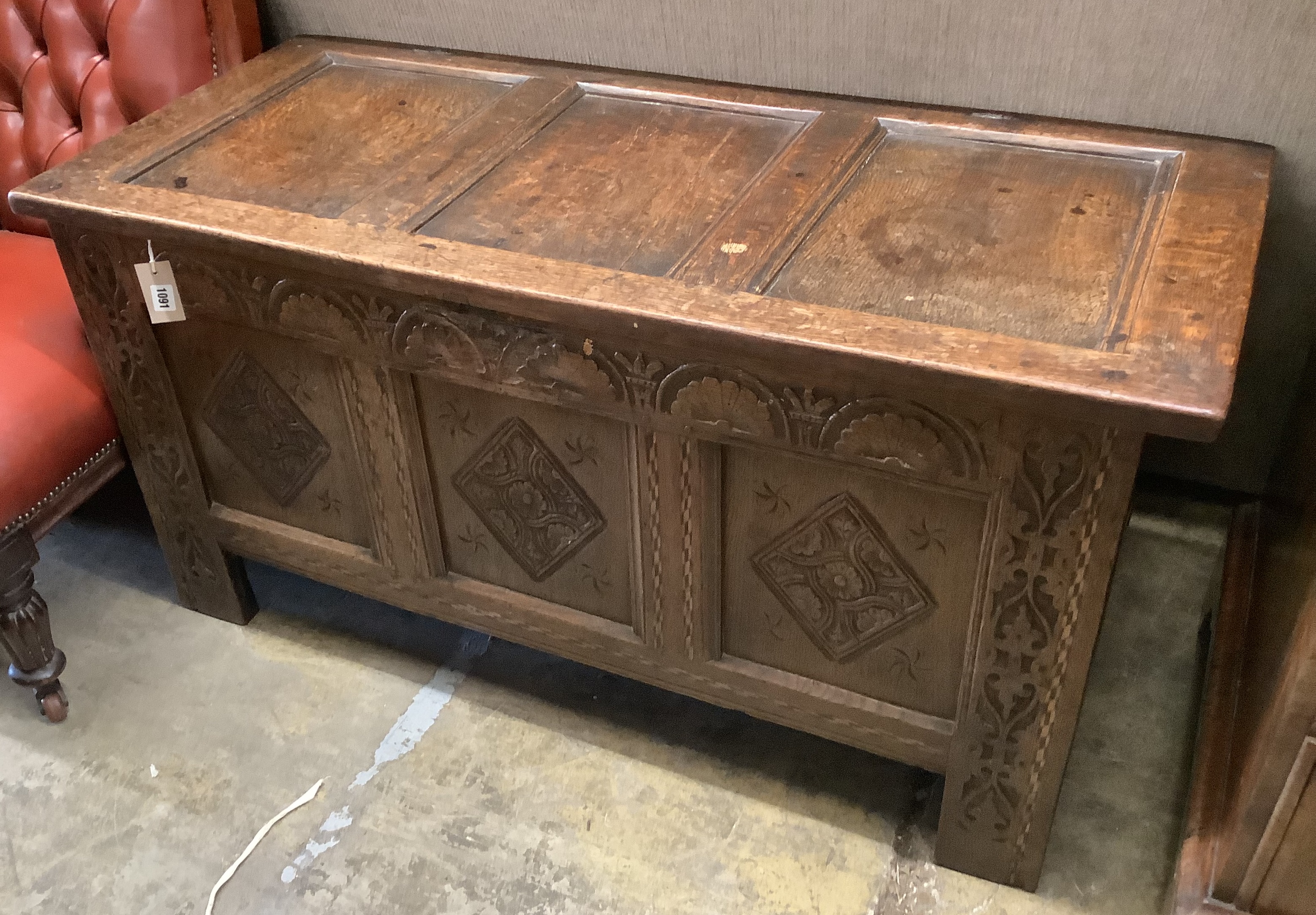 A 17th / 18th century panelled carved oak coffer, length 122cm, depth 53cm, height 61cm